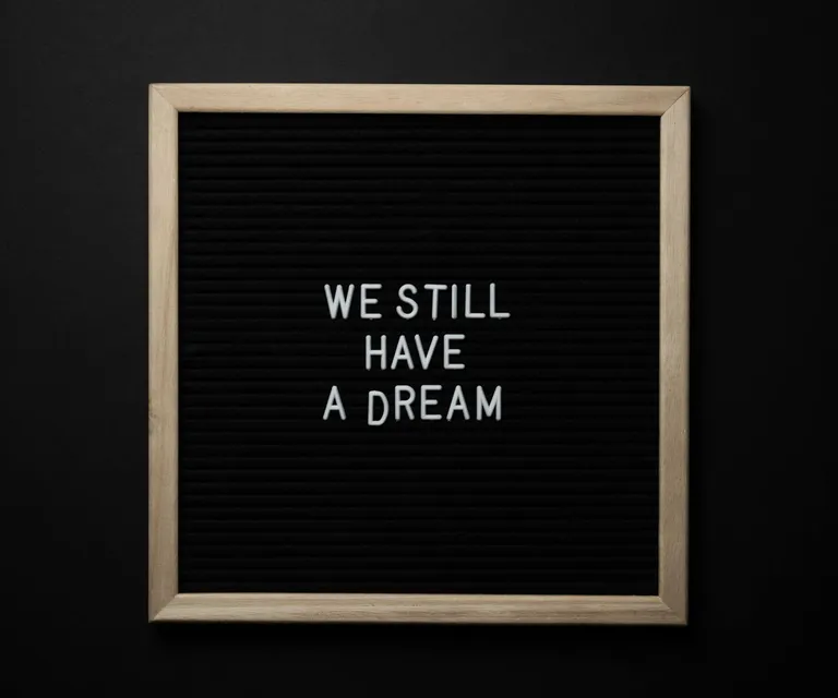 A black letterboard featuring the phrase 'We