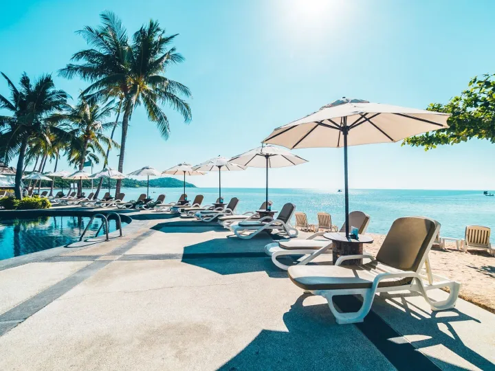 A quiet beach with a parasol looking out to a calm sea
