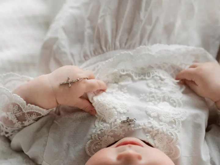High angle cute baby holding cross
