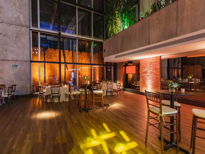 A bright hall set out with tables and chairs for an event