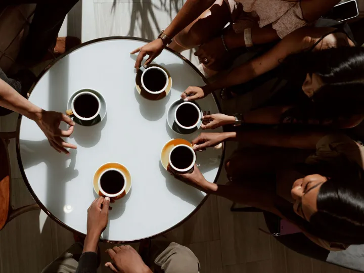 Group of friends gathered around a table, sharing