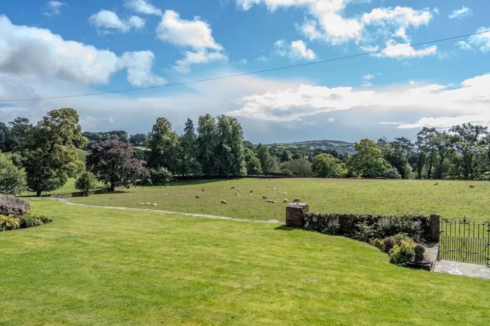 View across the lawn and sheep pasture to the hills of the Dane valley