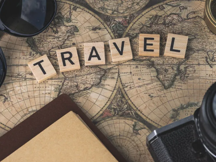 Vintage map with travel essentials like camera