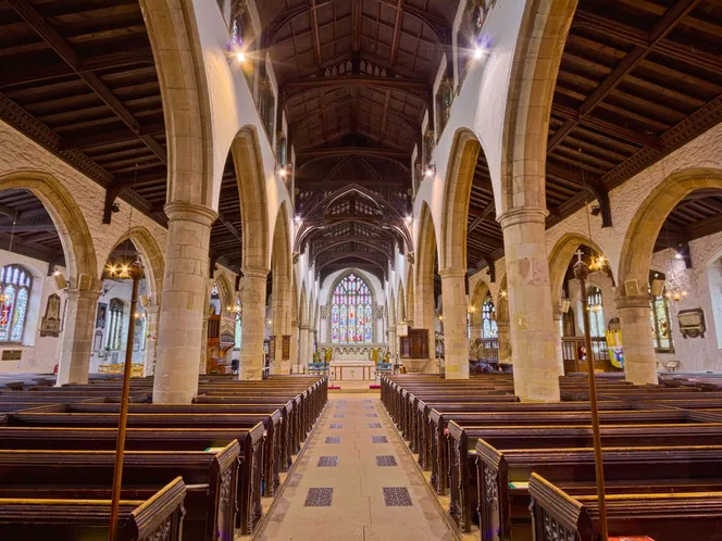 The empty nave and pews of an English parish church before a service