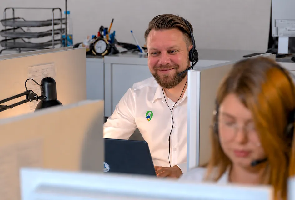 Smiling Parish Council Pigeon support team members wearing headsets at their desks