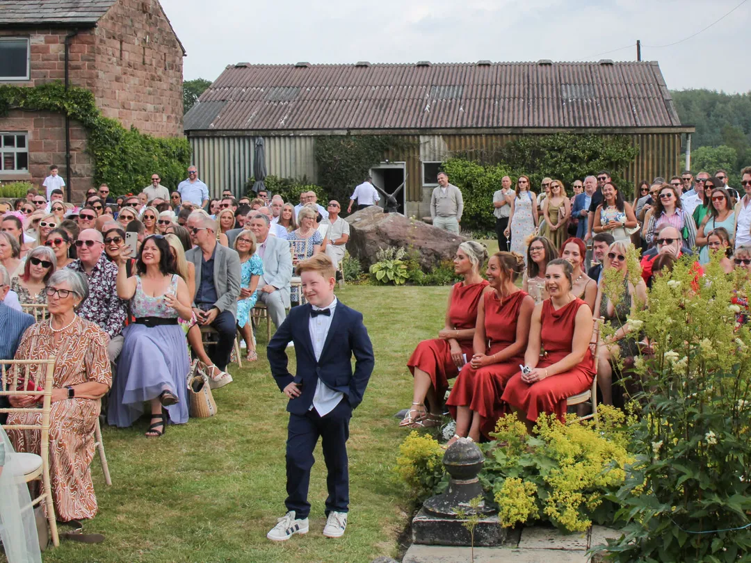 Guests seated on the lawn for an outdoor wedding ceremony at Mellor Knowl Farm