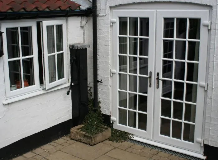 French doors with white brick courtyard