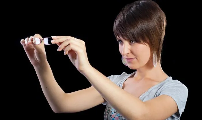 Woman inspects spectacles