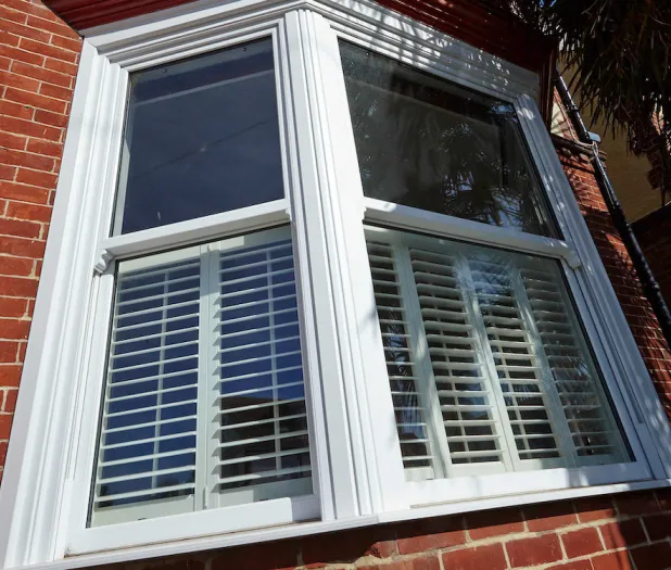 Sash window with blinds on red brick
