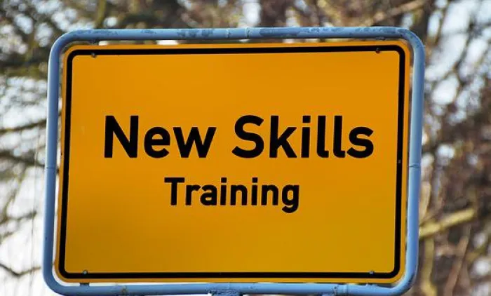 Yellow road sign reading New Skills Training