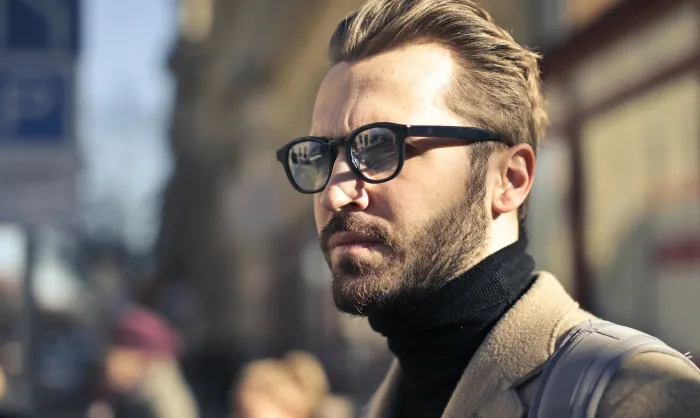 Man with coat and glasses