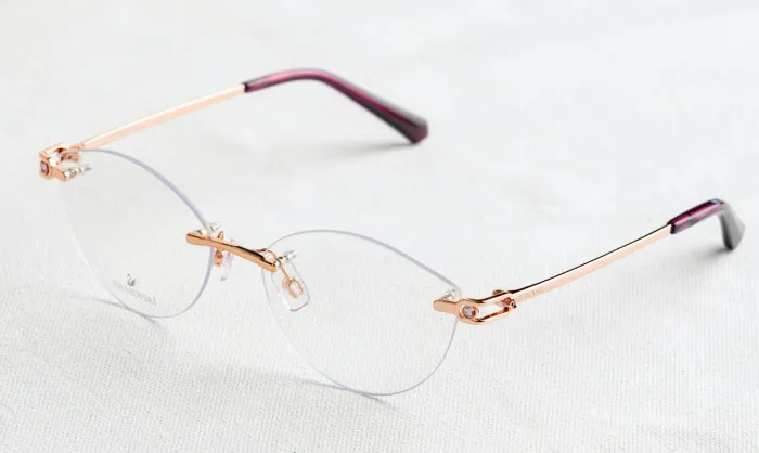 Rimless glasses on white fabric