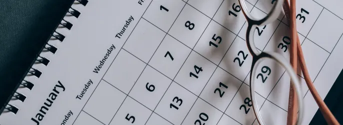 Brown-Framed Eyeglasses on a Calendar