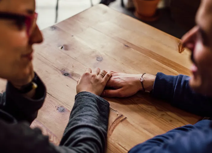 Man and Woman Sitting Together in Front of Table