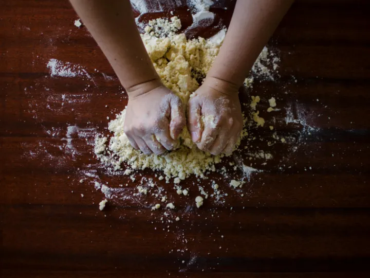 Person Mixing Dough