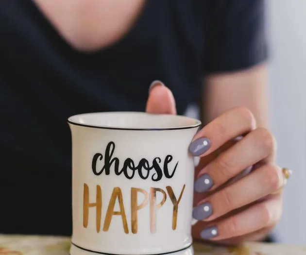 Selective Focus Photography of Person Touch the White Ceramic Mug With Choose Happy Graphic