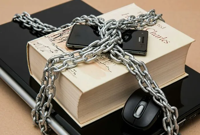 Black Android Smartphone on Top of White Book
