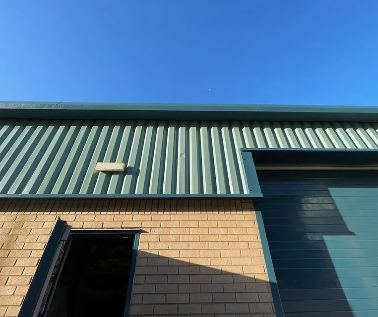Close-up of green-roofed warehouse building