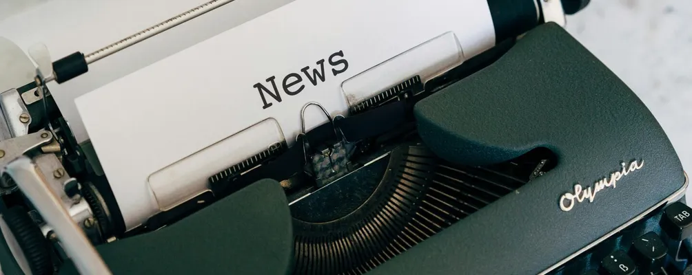 Close-up of an antique typewriter with 'News' on