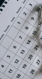 A close-up of a January calendar with eyeglasses
