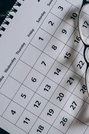 A close-up of a January calendar with eyeglasses