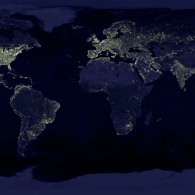 Satellite view of Earth at night with illuminated cities across continents.