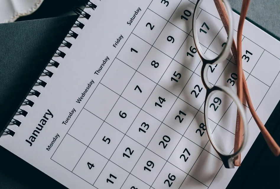 A close-up of a January calendar with eyeglasses