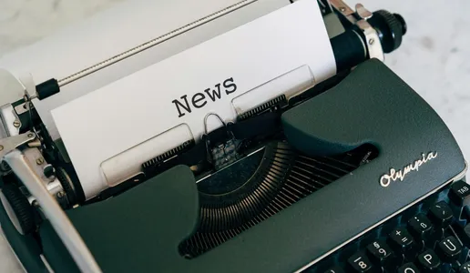 Close-up of an antique typewriter with 'News' on