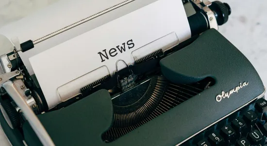 Close-up of an antique typewriter with 'News' on