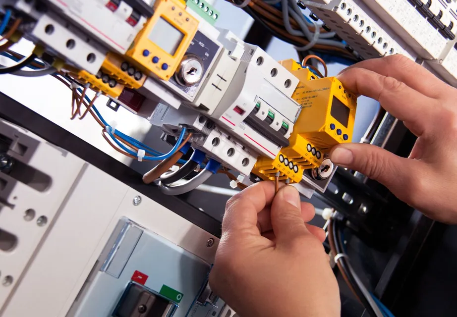 An electrician working with a fuse box