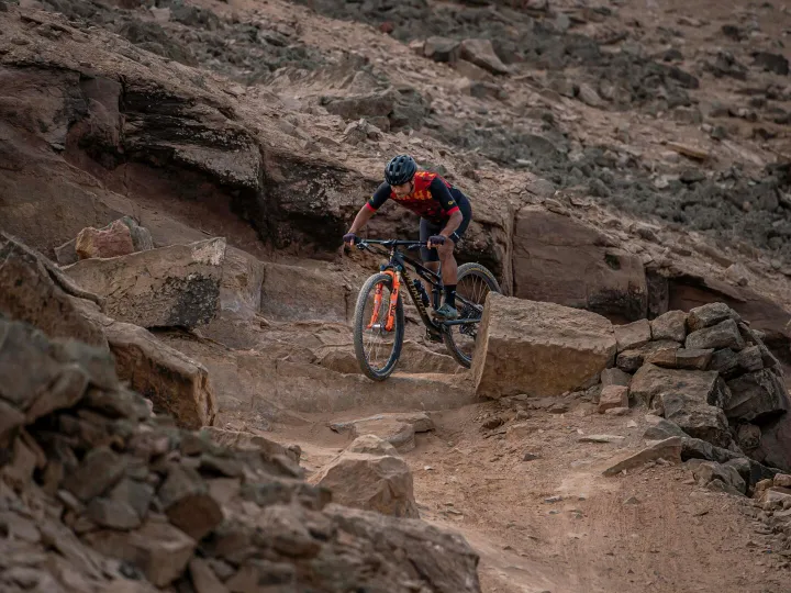 Cyclist navigating rocky mountain trail in Peru