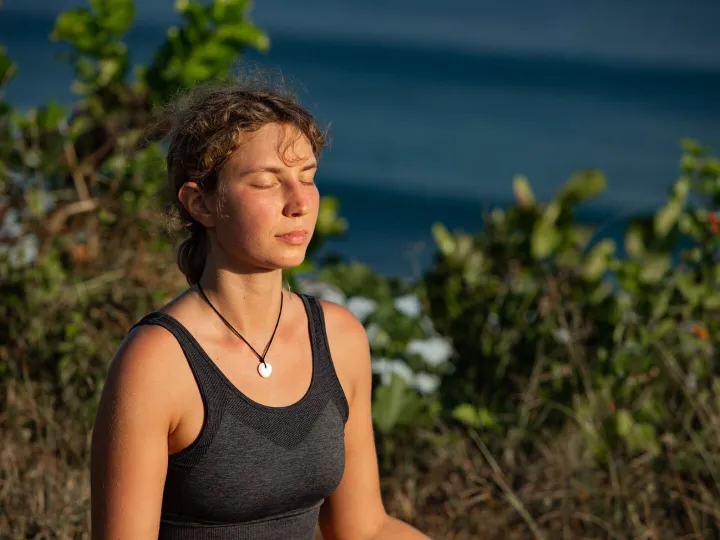 Young woman doing yoga outdoors with amazing back view. Bali