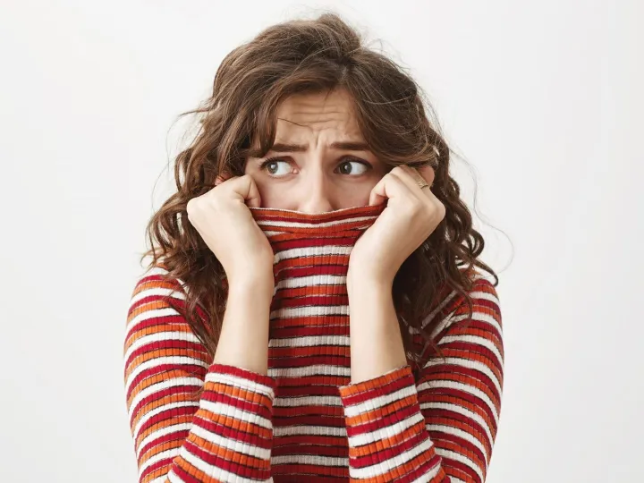 Scared timid woman looking left, shivering and