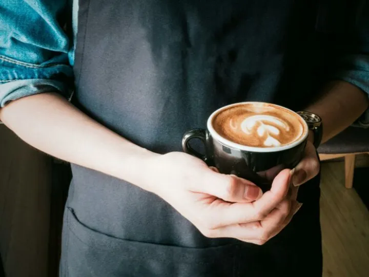 Woman Holding Mug of Cappuccino