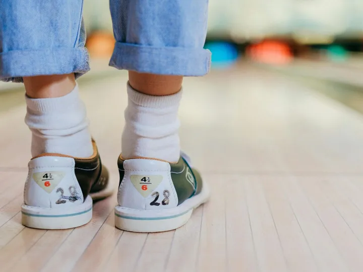 Close-up shot of a person wearing bowling shoes