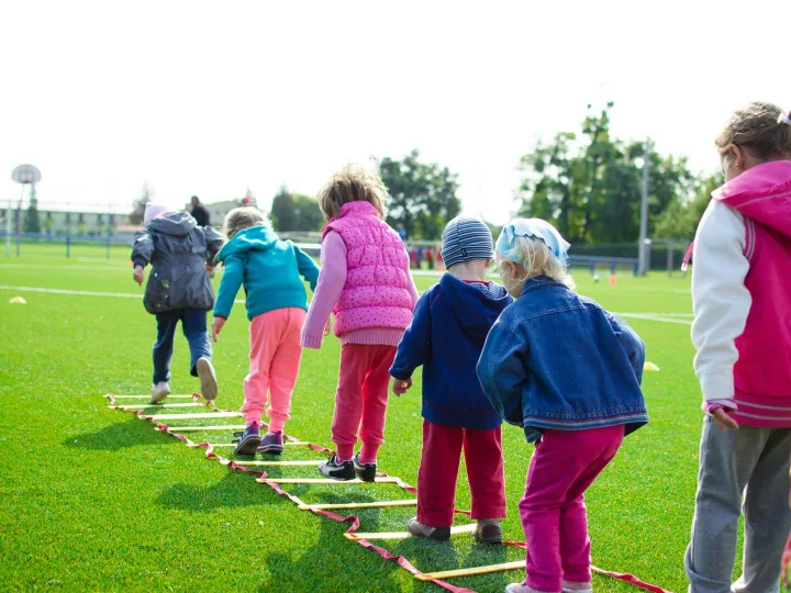 Children enjoy an outdoor activity on a grassy
