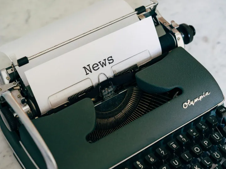 Close-up of an antique typewriter with 'News' on