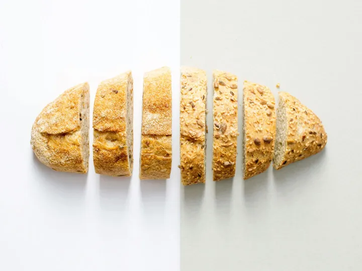 Freshly baked whole wheat bread sliced on a white 