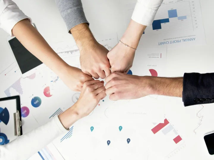 Colleagues celebrate success with a fist bump over