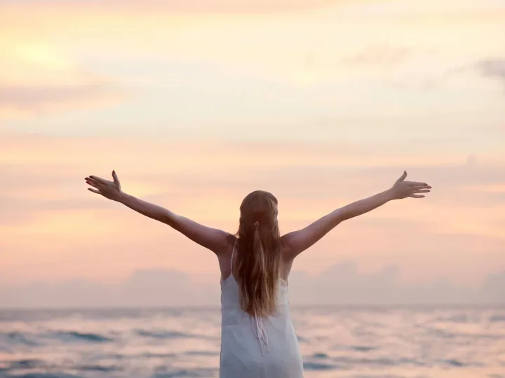 A woman enjoying a serene sunset on Unawatuna