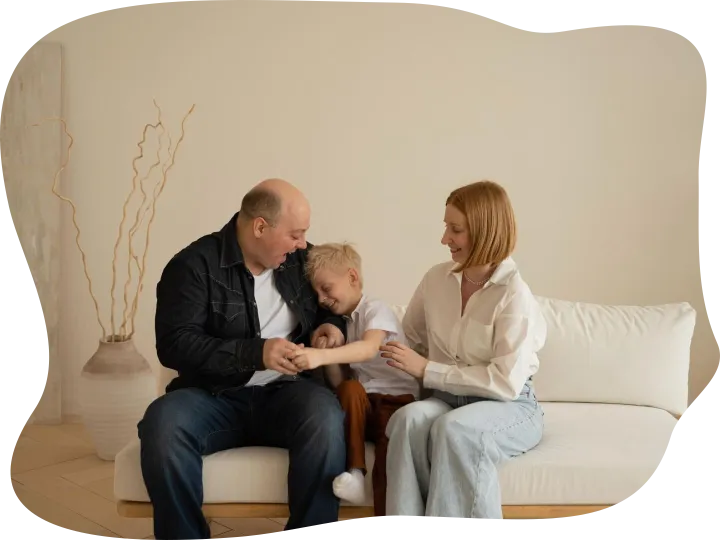 Happy family sitting on sofa in living room Father mother an