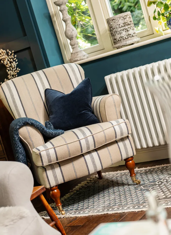 Cream striped chair in blue room