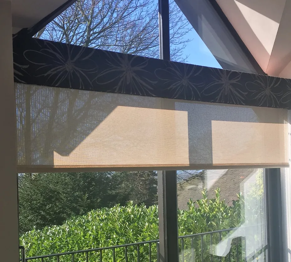 Peach roller blinds overlooking a garden