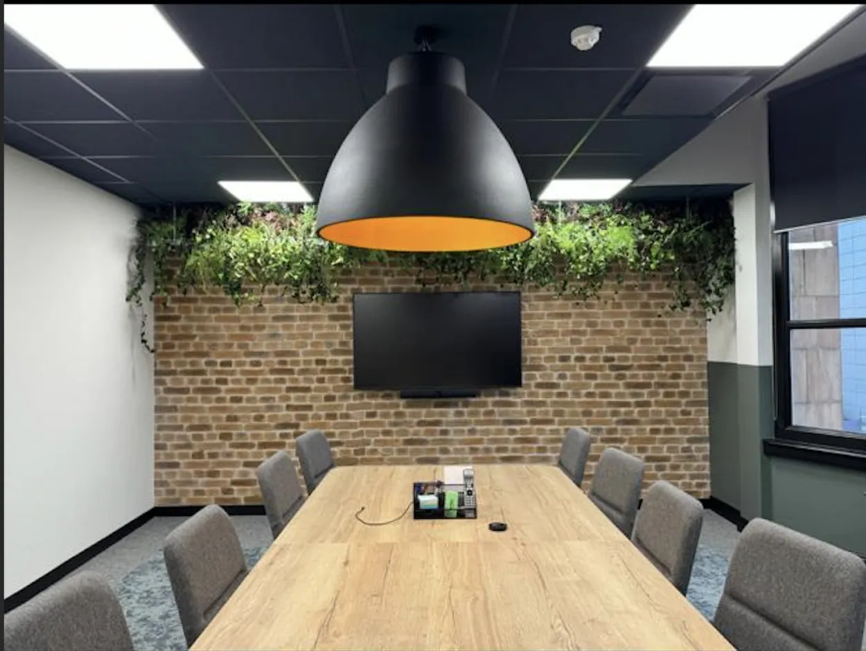 A Manchester office meeting room with a large overhead lamp