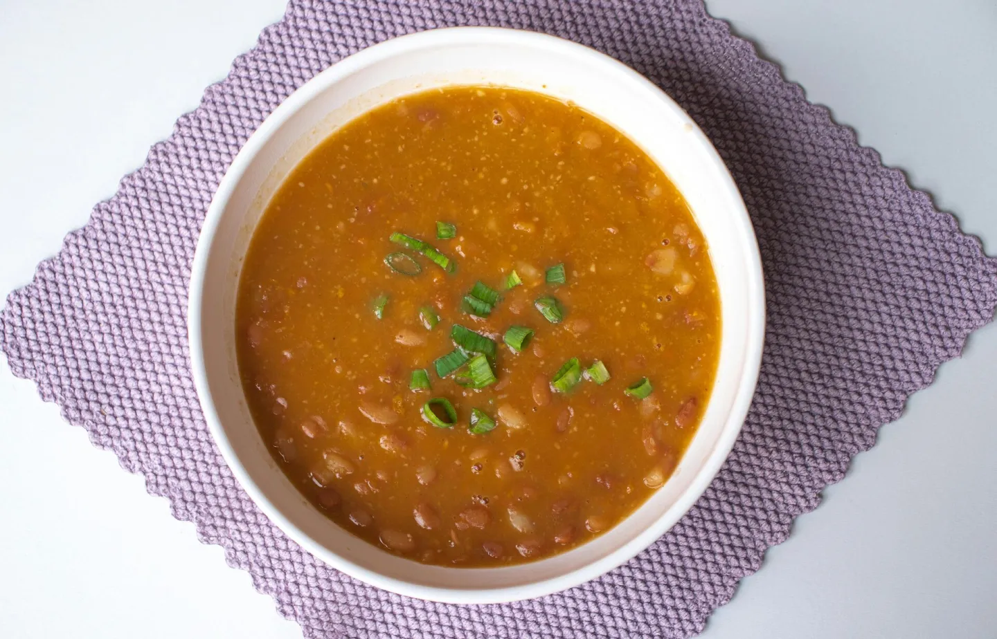 Hearty homemade bean soup garnished with green