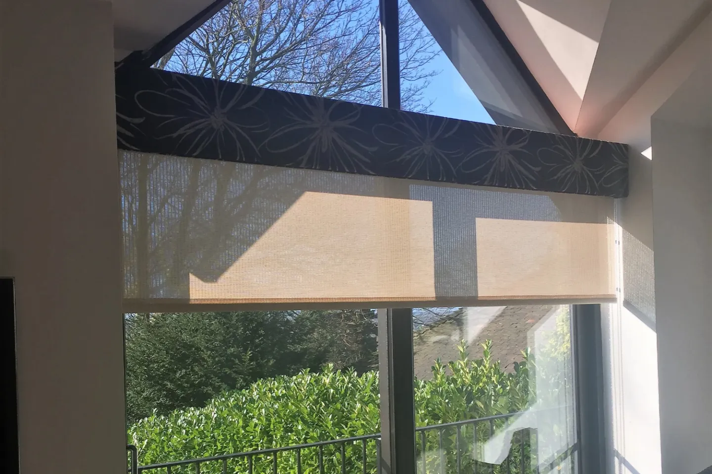 Peach roller blinds overlooking a garden