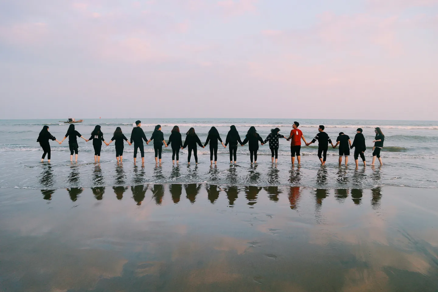 Team Holding Their Hands On Seashore