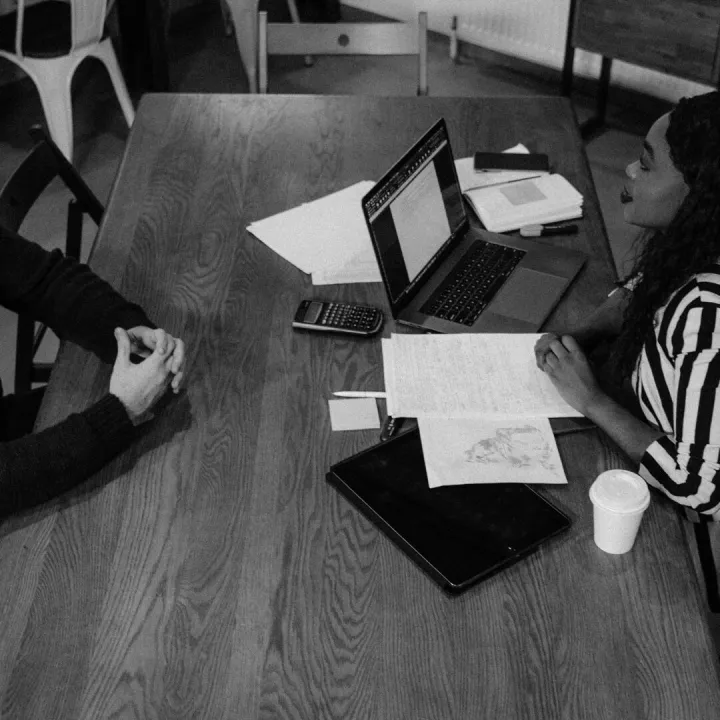 Colleagues discussing work at a table
