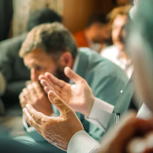 Friends praying together at a small group meeting