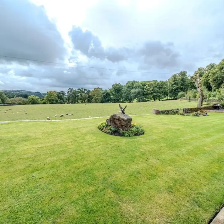 The lawn and sheep fields at Mellor Knowl Farm under a big sky
